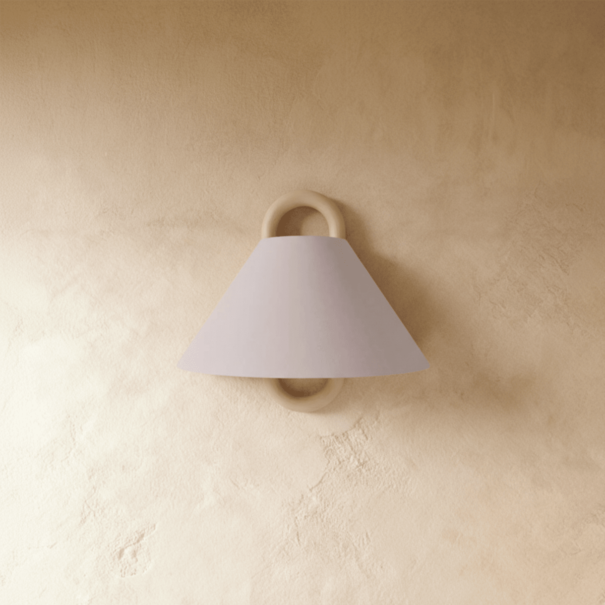 Clérachic wall sconce with a plain blush pink fabric cone shade on a solid wood ring bracket, unlit on a plaster wall.