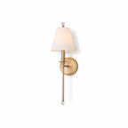 Gold-toned Clérachic wall light with a white fabric shade and glass ball ends, shown whole on a plain white backdrop.