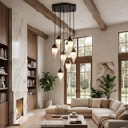 Black-capped alabaster drops cluster on this Clérachic chandelier, hung above a living room with a stone fireplace.