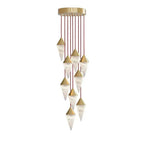 A dense spiral of brass-capped drops on this Clérachic chandelier cascades down red cords, on a plain background.