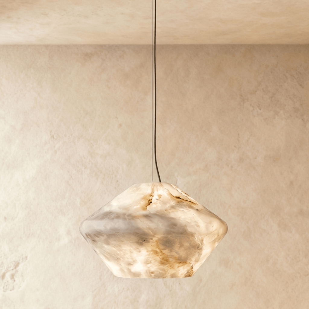 Clérachic alabaster pendant with a faceted double-cone shade of veined cream stone, glowing warm on a slim cable.