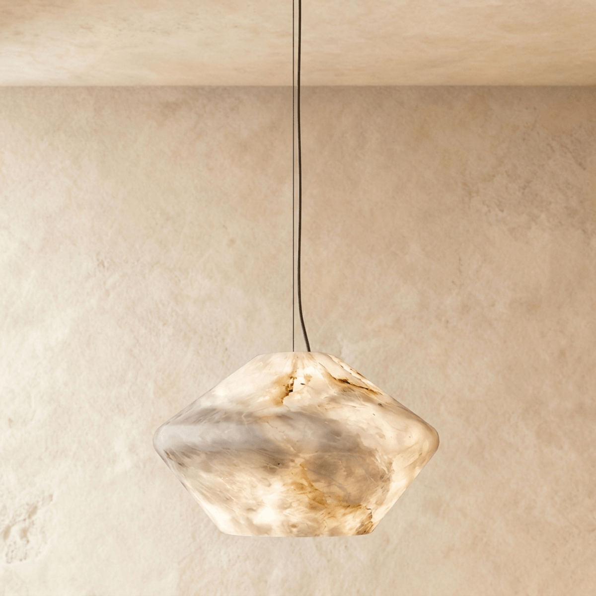 Clérachic alabaster pendant with a faceted double-cone shade of veined cream stone, glowing warm on a slim cable.