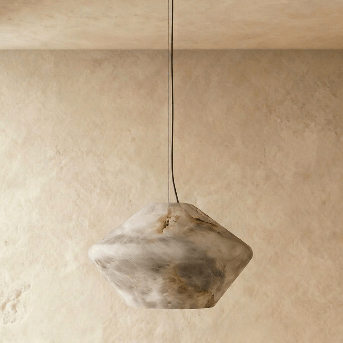 Clérachic alabaster pendant switched off, showing the grey and honey veining of its faceted double-cone stone shade.