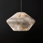 Clérachic alabaster pendant on a thin cable against a black backdrop, its cloudy white and amber veining lit from within.