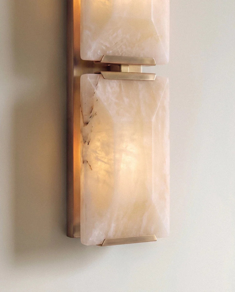 Close view of two stacked alabaster panels on the Clérachic wall light, joined by brass clips on a brass backplate