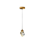 Clérachic single crystal pendant light hanging from a round gold canopy on a fine cord, shown on a plain white ground.