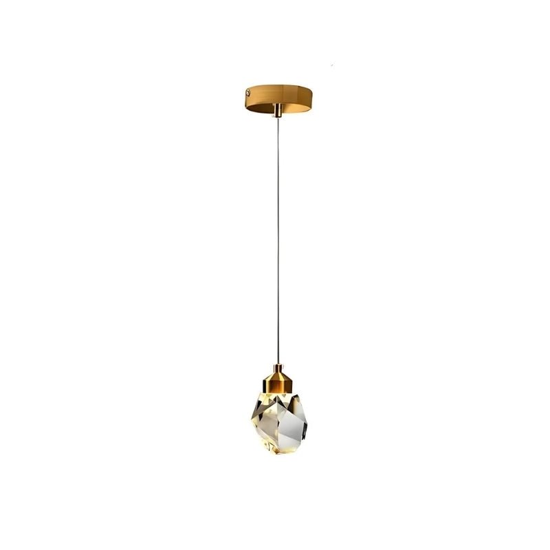 Clérachic single crystal pendant light hanging from a round gold canopy on a fine cord, shown on a plain white ground.