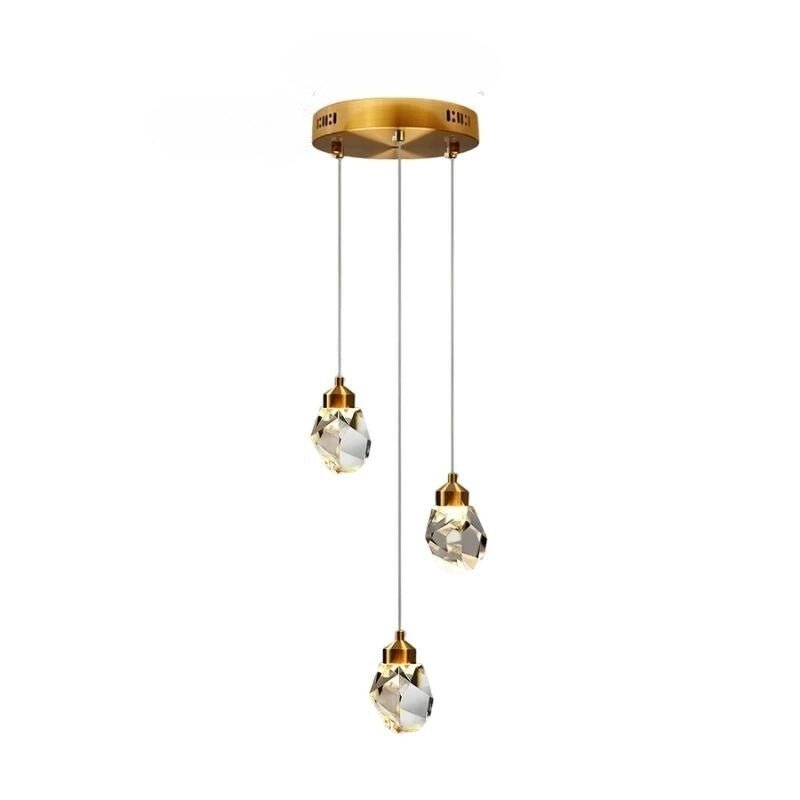 Clérachic three-head round crystal pendant light with faceted drops at staggered heights below a gold circular canopy.