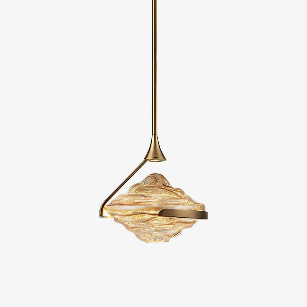 A faceted amber glass shade with a gold arm and slim gold rod hangs against a plain white backdrop, shown as this Clérachic pendant.