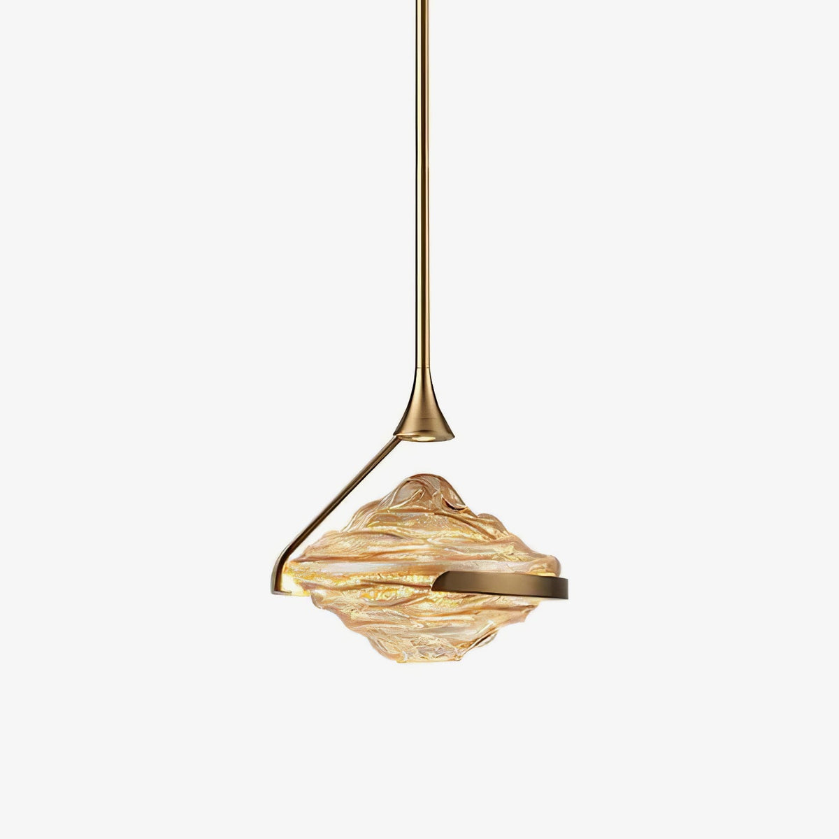 A faceted amber glass shade with a gold arm and slim gold rod hangs against a plain white backdrop, shown as this Clérachic pendant.