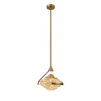A faceted amber glass pendant on a gold rod and ceiling plate hangs against a plain white backdrop, a Clérachic pendant.