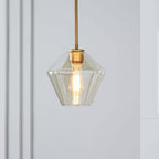 Champagne-amber taper of the Clérachic faceted glass pendant light, its brass collar meeting the socket at the neck.