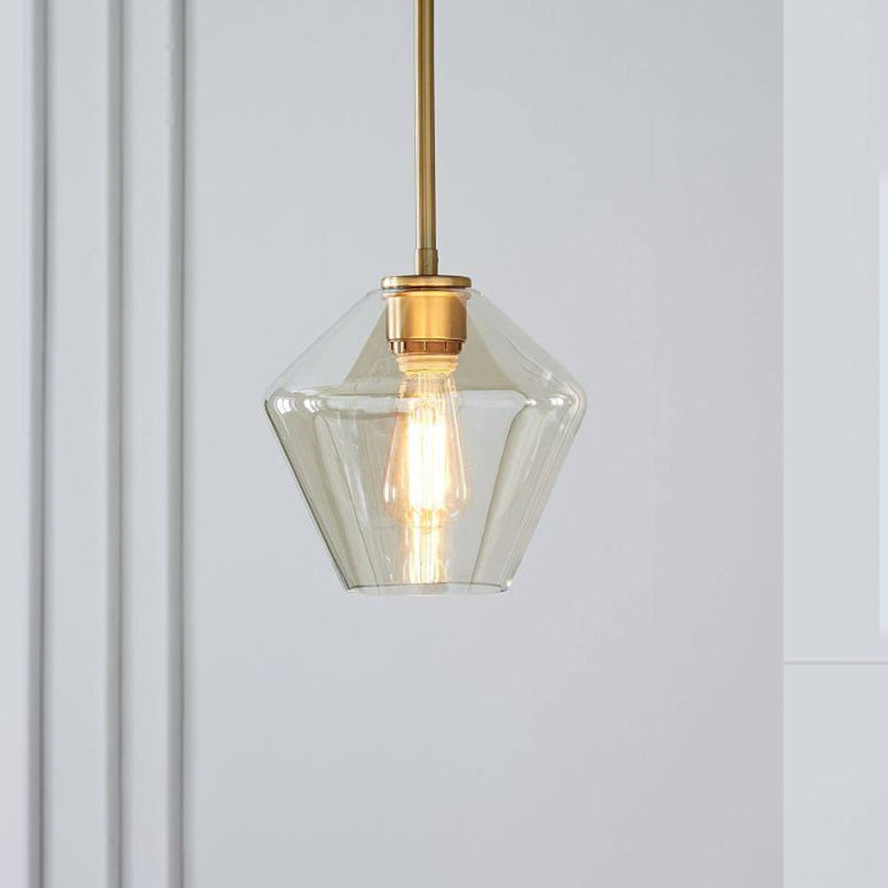 Champagne-amber taper of the Clérachic faceted glass pendant light, its brass collar meeting the socket at the neck.