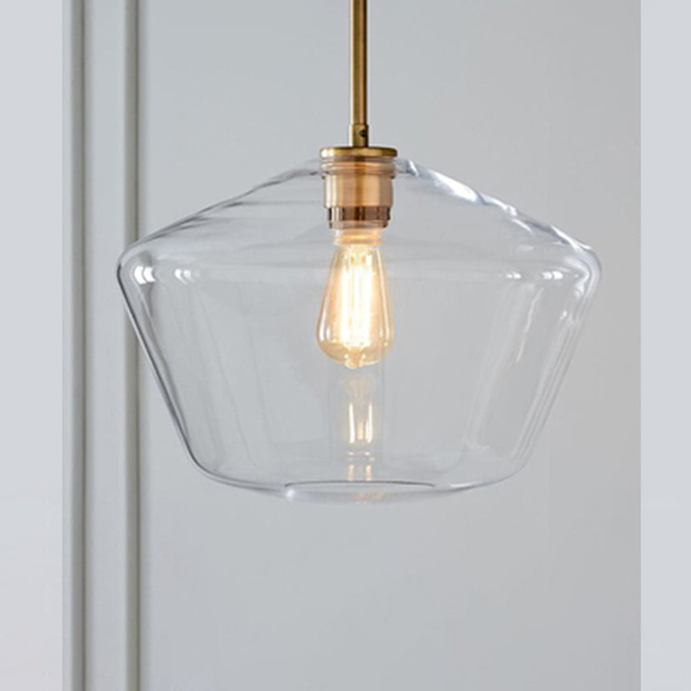 Clérachic faceted glass pendant light in the wide clear flared bowl, filament bulb reflected across the pinched shoulder.