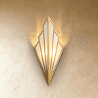 Clérachic Art Deco wall lamp in gold, a fan of linen panels in a slim metal frame, glowing warm on a limewashed wall.