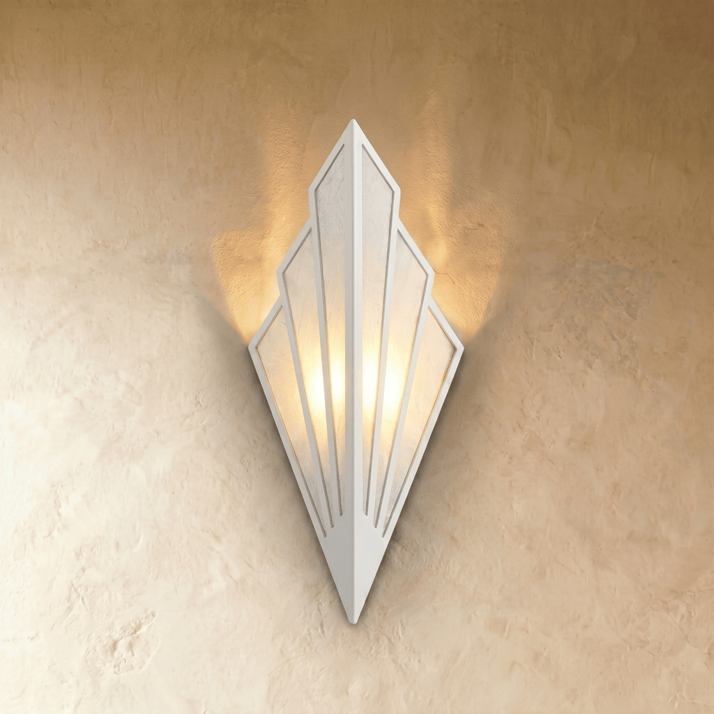 Clérachic Art Deco wall lamp in white, fan-shaped linen panels in a white metal frame, casting warm light up the wall.