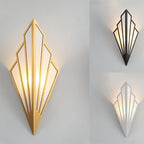 Clérachic Art Deco wall lamp shown in gold, with smaller black and white versions at the right, all lit warm on grey.