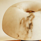 Close view of the veined, marbled shade of this Clérachic lamp, with a small brass cap at the centre.