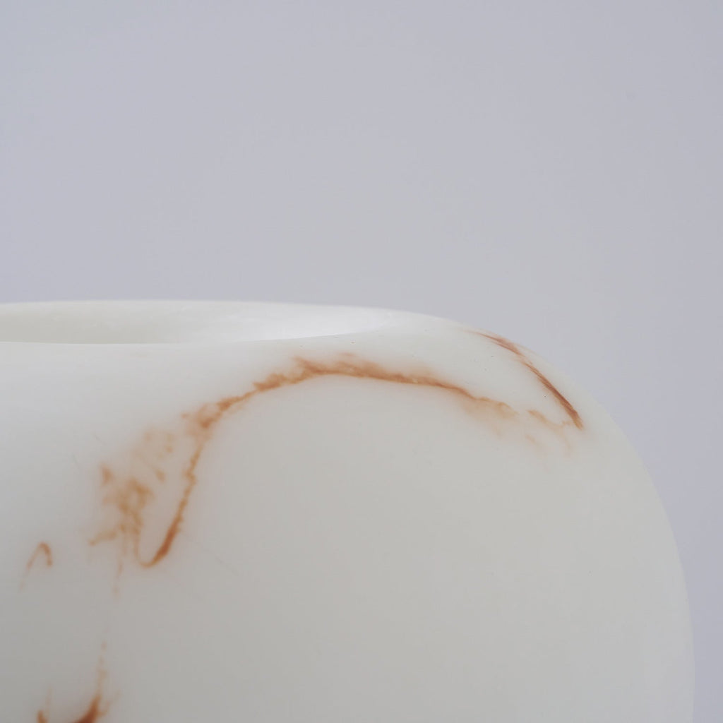 Close view of the rounded edge of the shade on this Clérachic lamp, with a fine rust-coloured vein across the white.