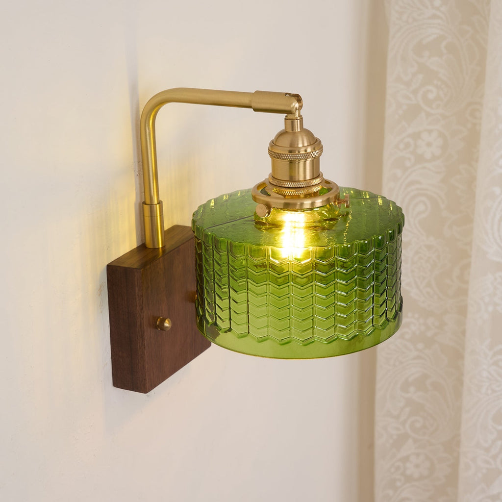 Clérachic fish-scale glass wall sconce seen from above beside a lace curtain, the green drum's flat glass top catching the light.