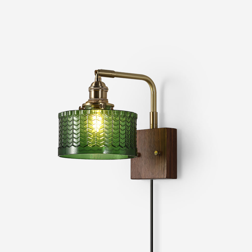 Studio shot of the Clérachic fish-scale glass wall sconce on white, green drum facing left above its slim plug-in cord.