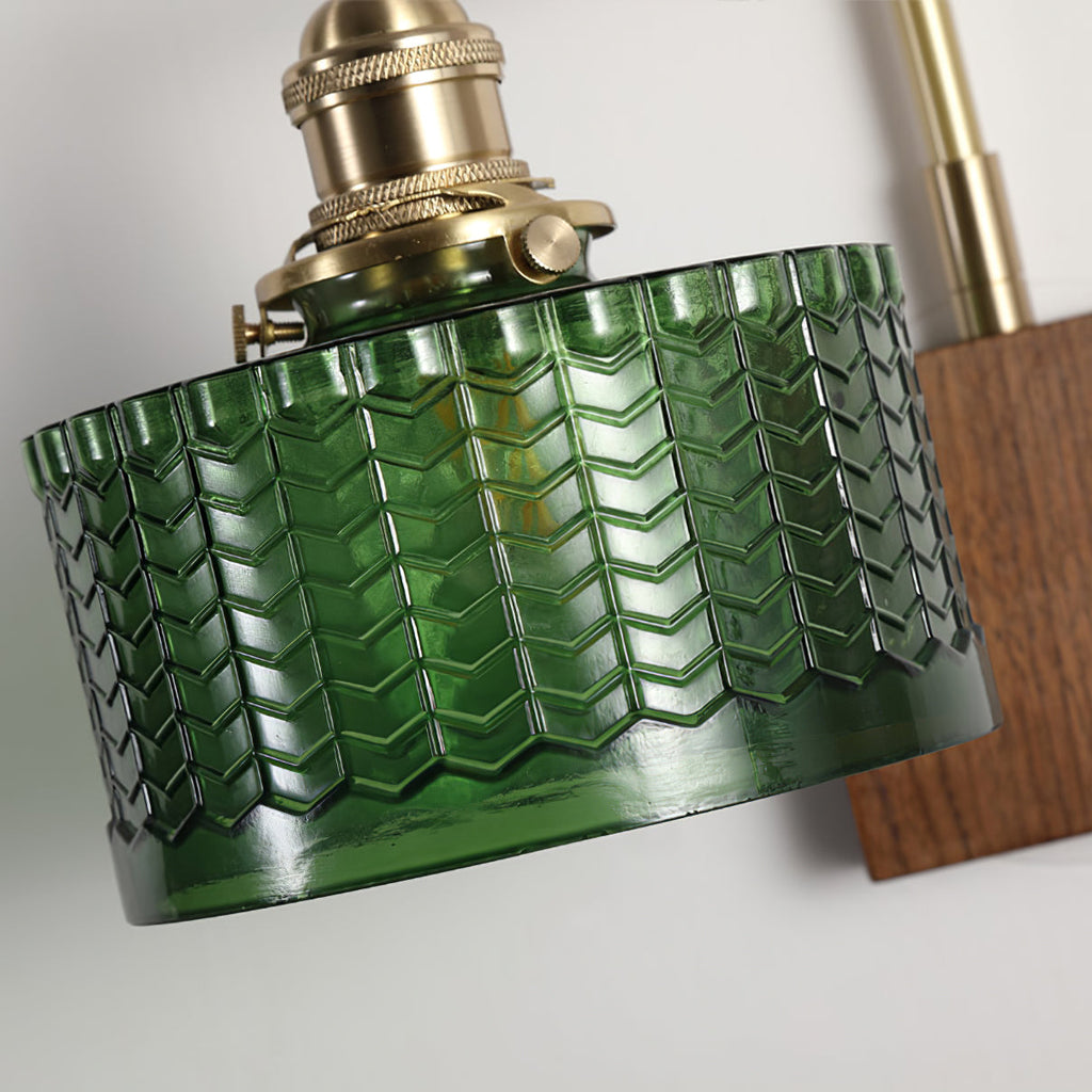Detail of the Clérachic fish-scale glass wall sconce showing the brass thumbscrews that clamp the green glass drum in place.