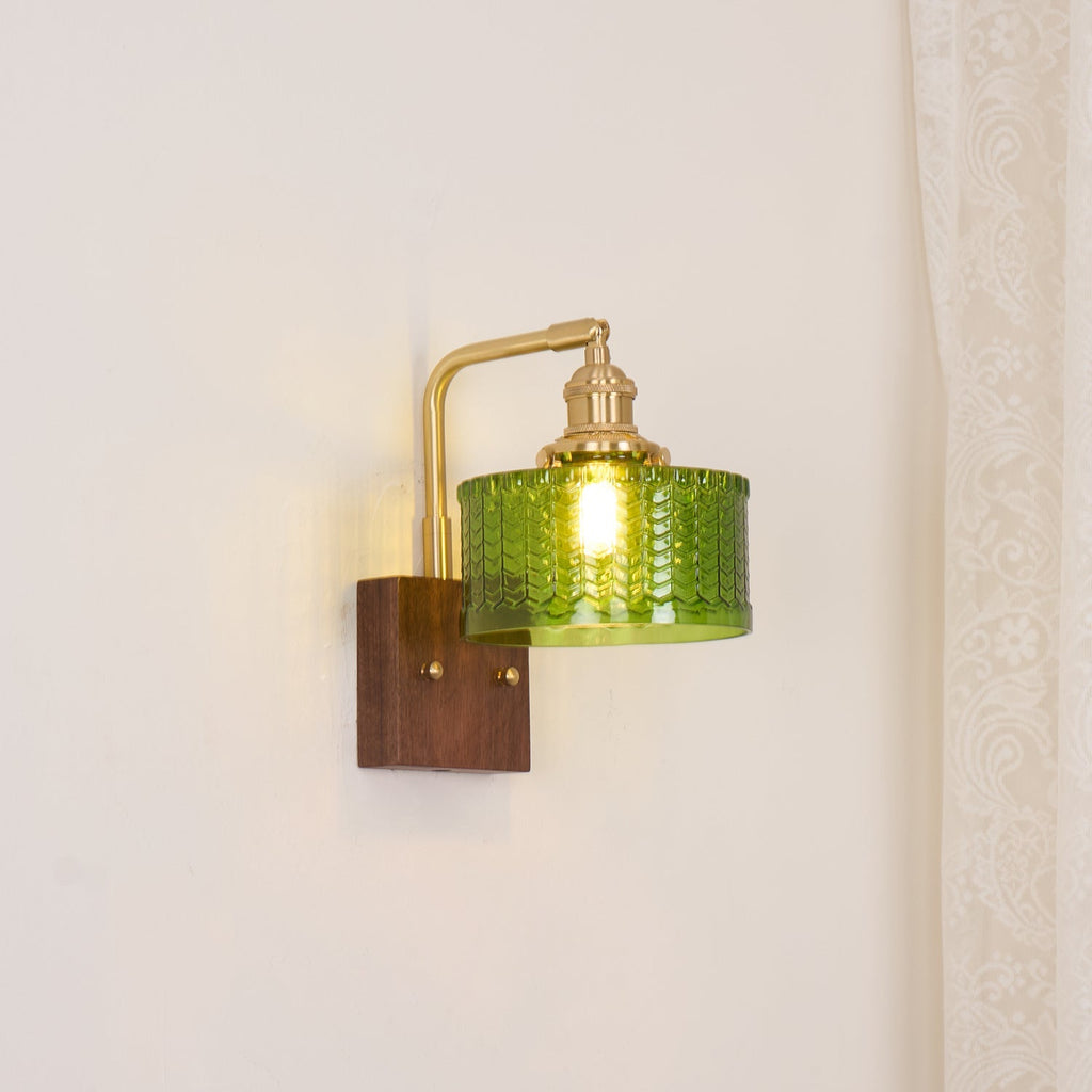 Clérachic fish-scale glass wall sconce set against a cream wall, scaled for a bedside table rather than for a statement.