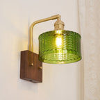 Clérachic fish-scale glass wall sconce viewed from the side, the cord exit drilled through the underside of the walnut block.
