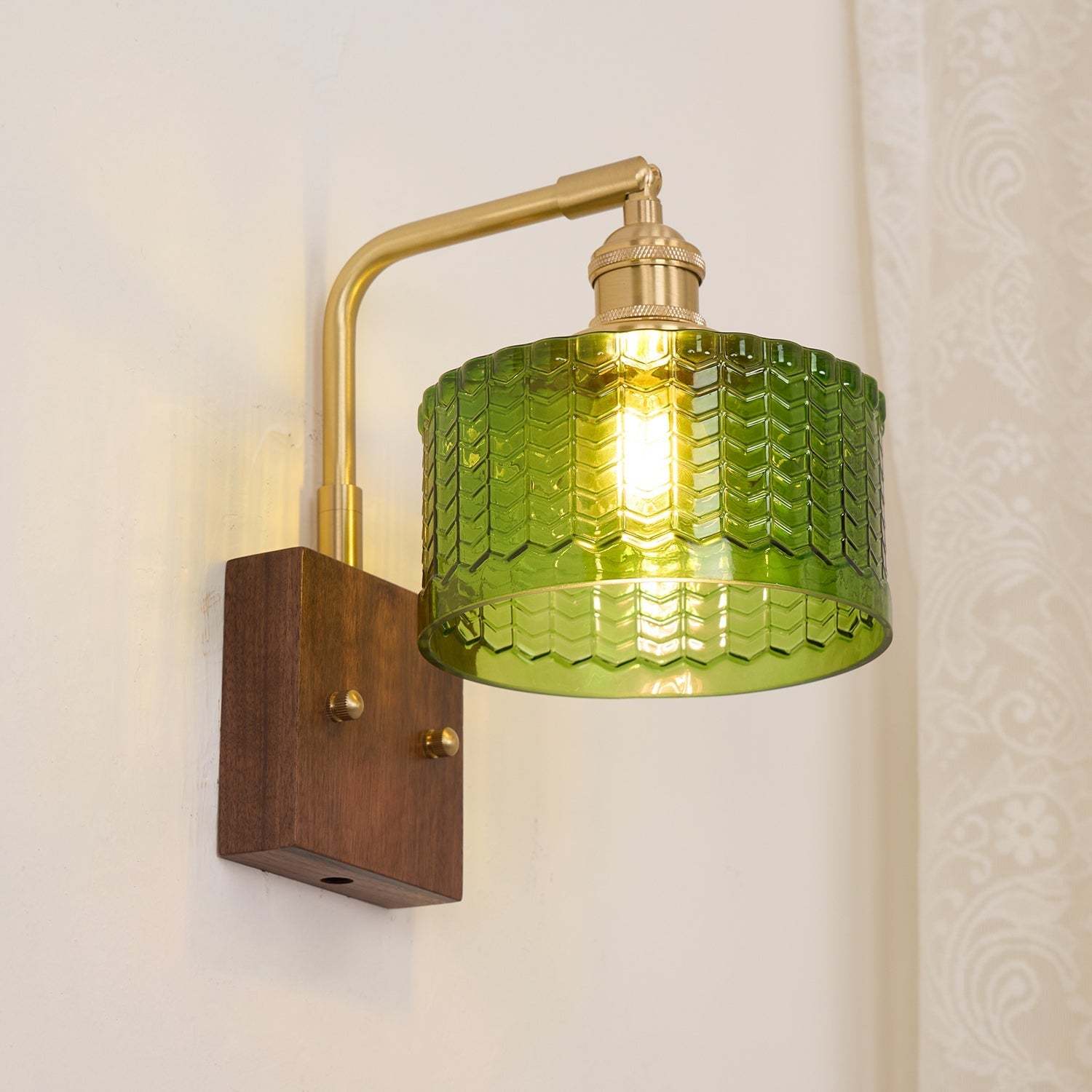 Clérachic fish-scale glass wall sconce viewed from the side, the cord exit drilled through the underside of the walnut block.