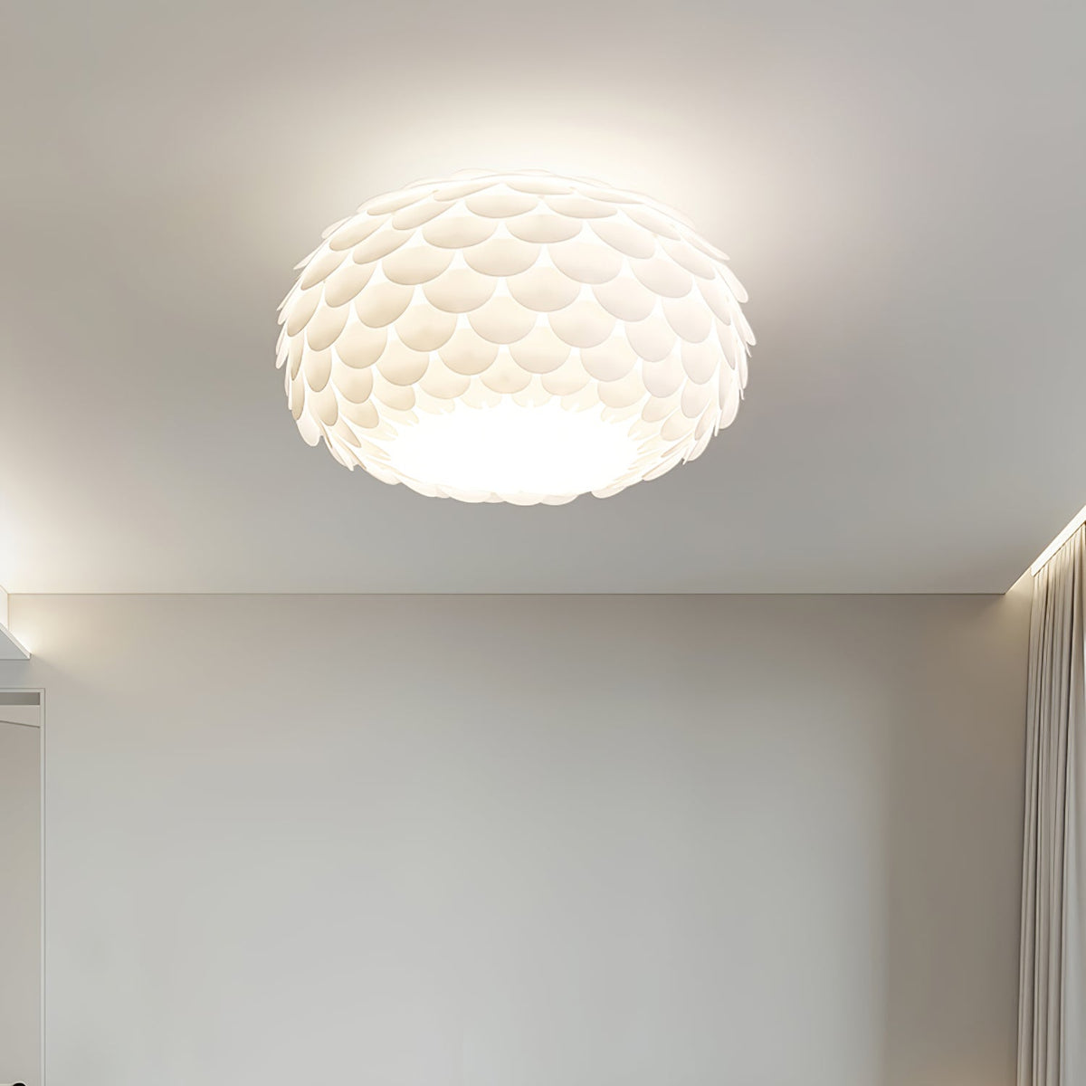 This Clérachic ceiling light lit above a plain grey wall with a soft shadow line along the ceiling edge.