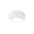 White fish-scale Clérachic ceiling light with its shape softly lit from below, on a plain white background.