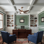 A Clérachic five-blade ceiling fan hangs in a panelled study with built-in bookcases, a dark wood desk and two navy armchairs.