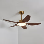 The Clérachic ceiling fan from below, five walnut-grain blades and a gold motor housing, with its light on in a warm white.