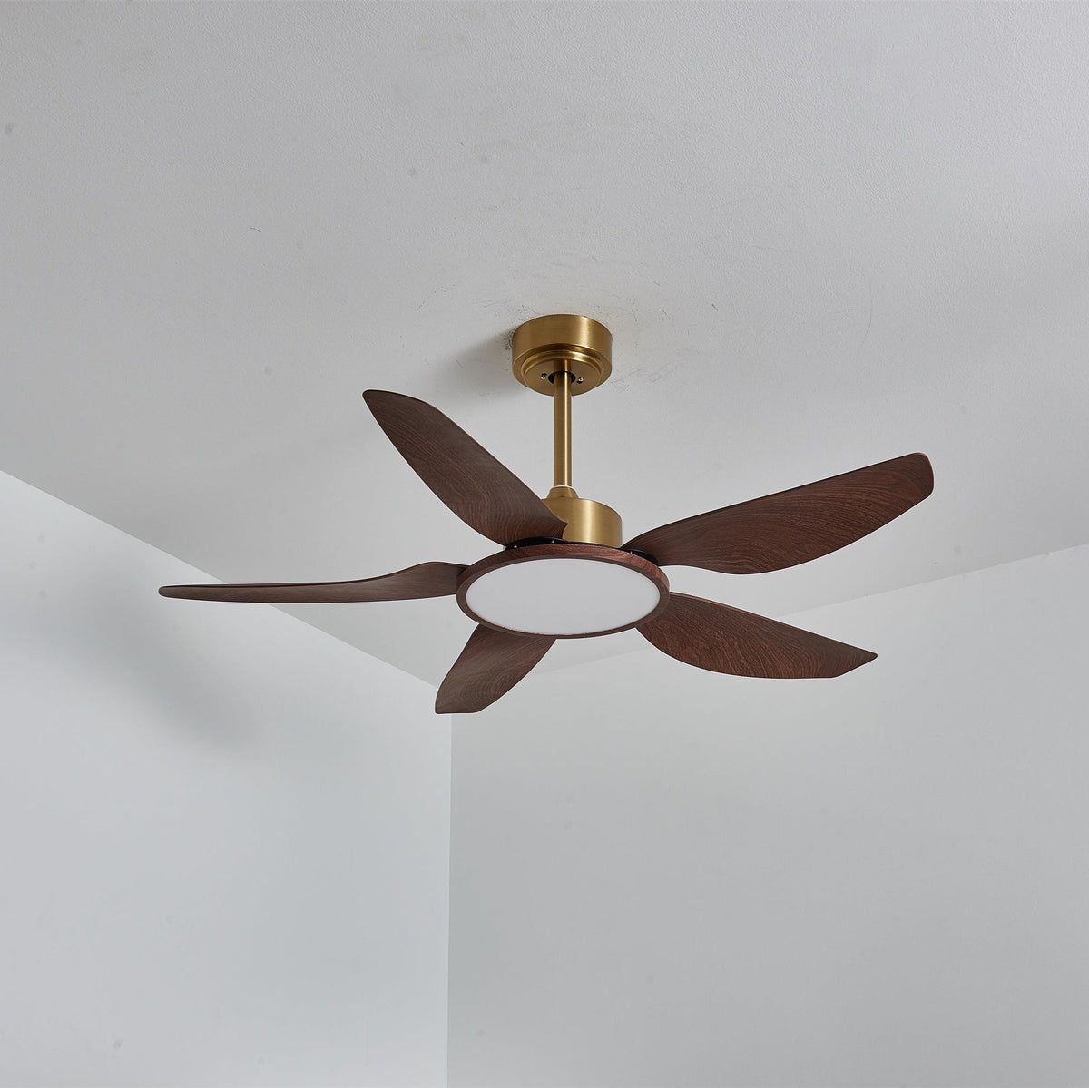 The Clérachic ceiling fan with its light switched off, the round diffuser pale and the five walnut-grain blades fully visible.