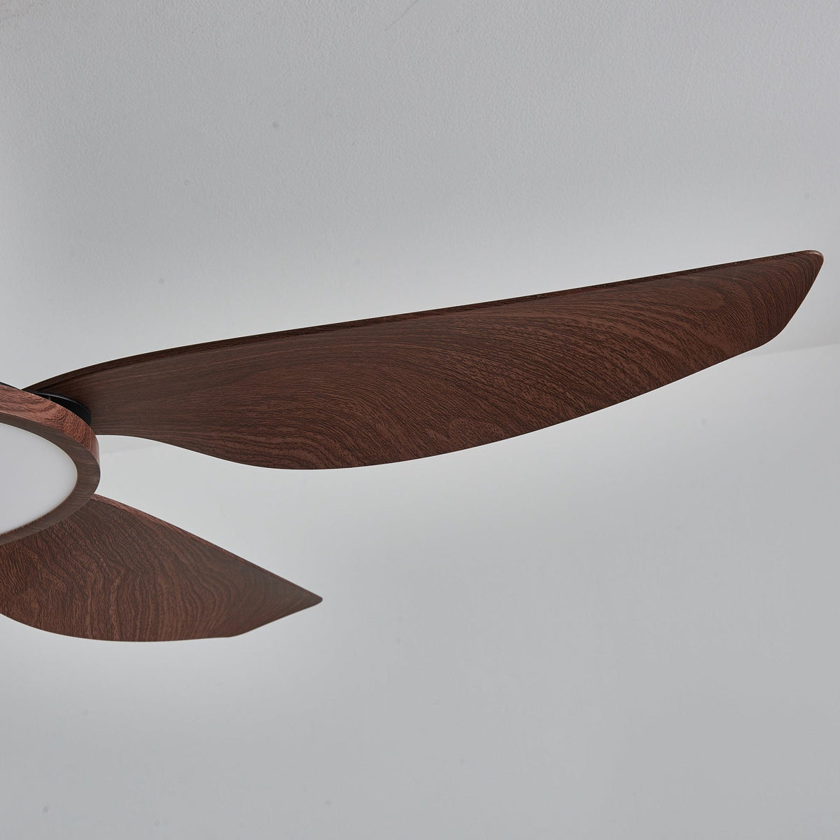 Close view of the long, tapering tip of a walnut-grain blade on this Clérachic ceiling fan.