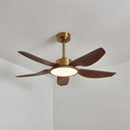 A Clérachic ceiling fan from the side, five walnut-grain blades under a gold down-rod, its round light glowing warm.