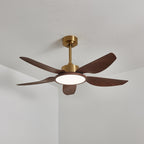 The Clérachic ceiling fan from the side with its round light on in a neutral white, below a gold canopy and down-rod.