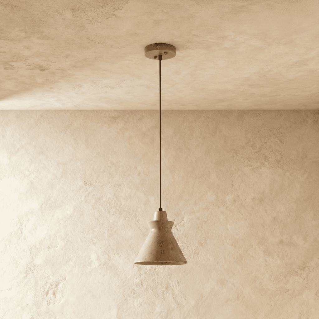 Clérachic pendant in pale yellow travertine with a flared cone shade and wooden top, hung from a round ceiling canopy