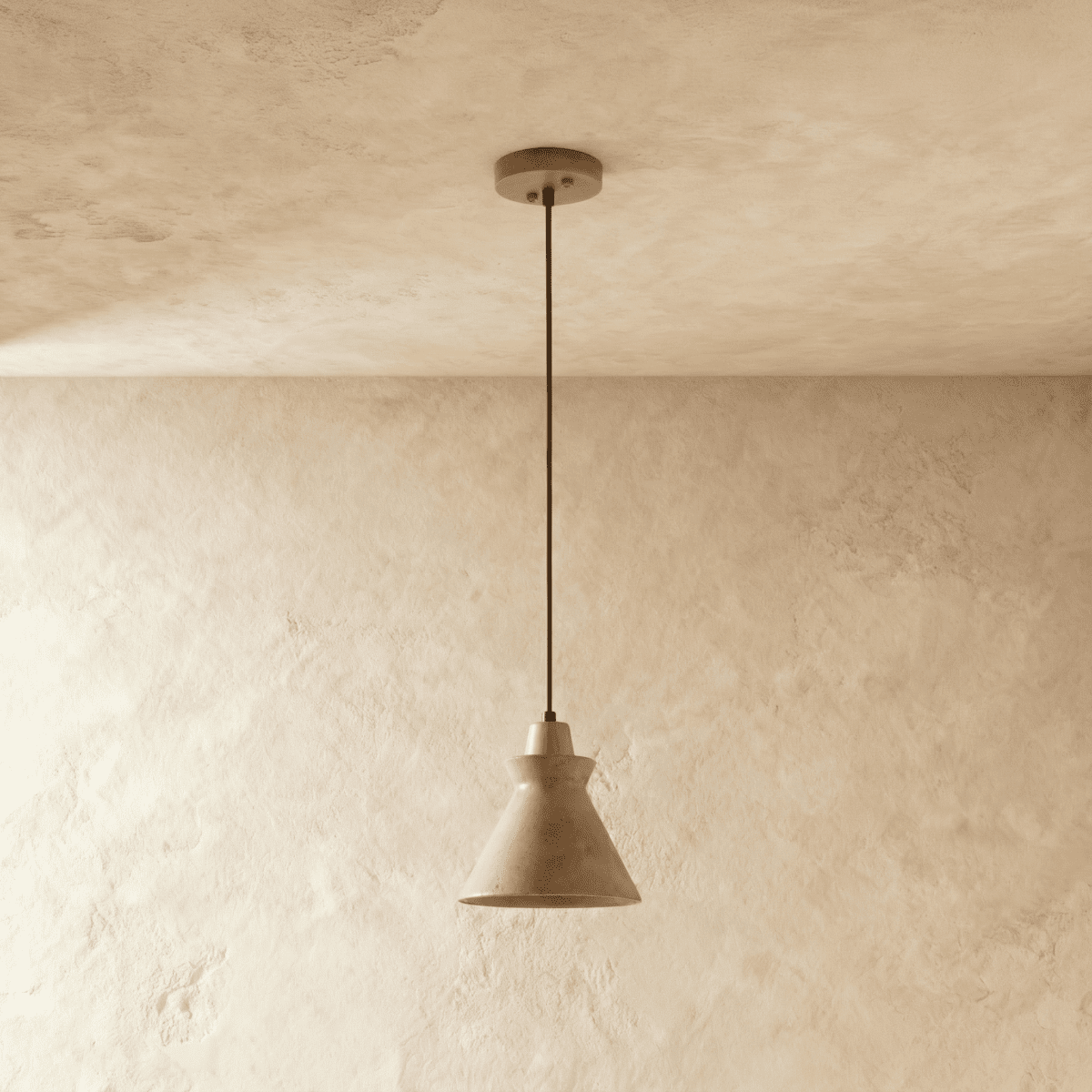 Clérachic pendant in pale yellow travertine with a flared cone shade and wooden top, hung from a round ceiling canopy