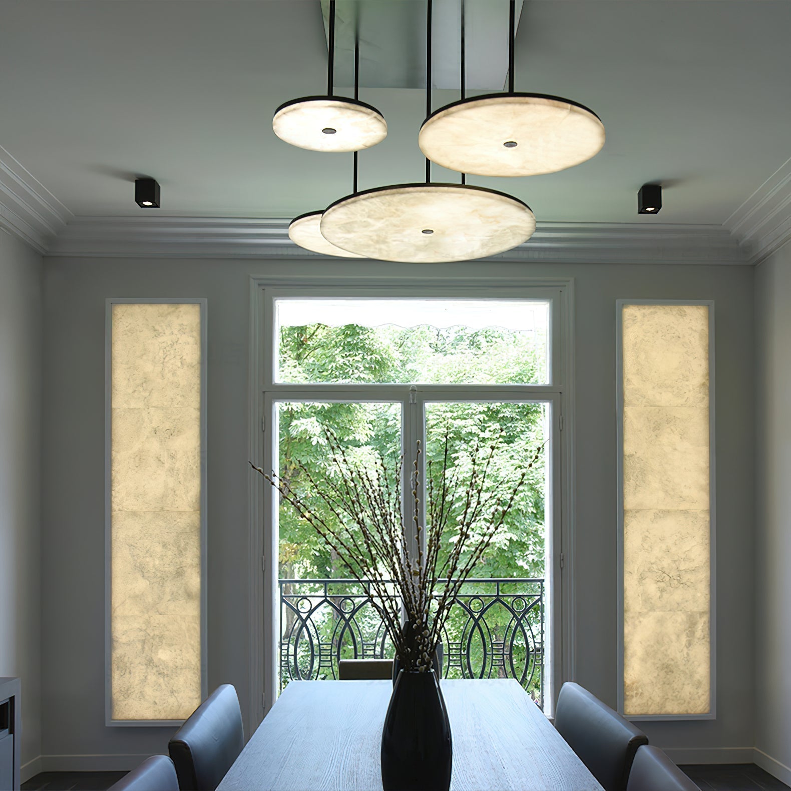 Three Clérachic Flat Disc Pendant Light fixtures grouped over a dining table in a panelled room with a tall garden window.