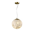 The Clérachic pendant in its larger size, the tiled alabaster globe glowing beneath a brushed brass canopy.