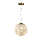 The Clérachic pendant in its larger size, the tiled alabaster globe glowing beneath a brushed brass canopy.