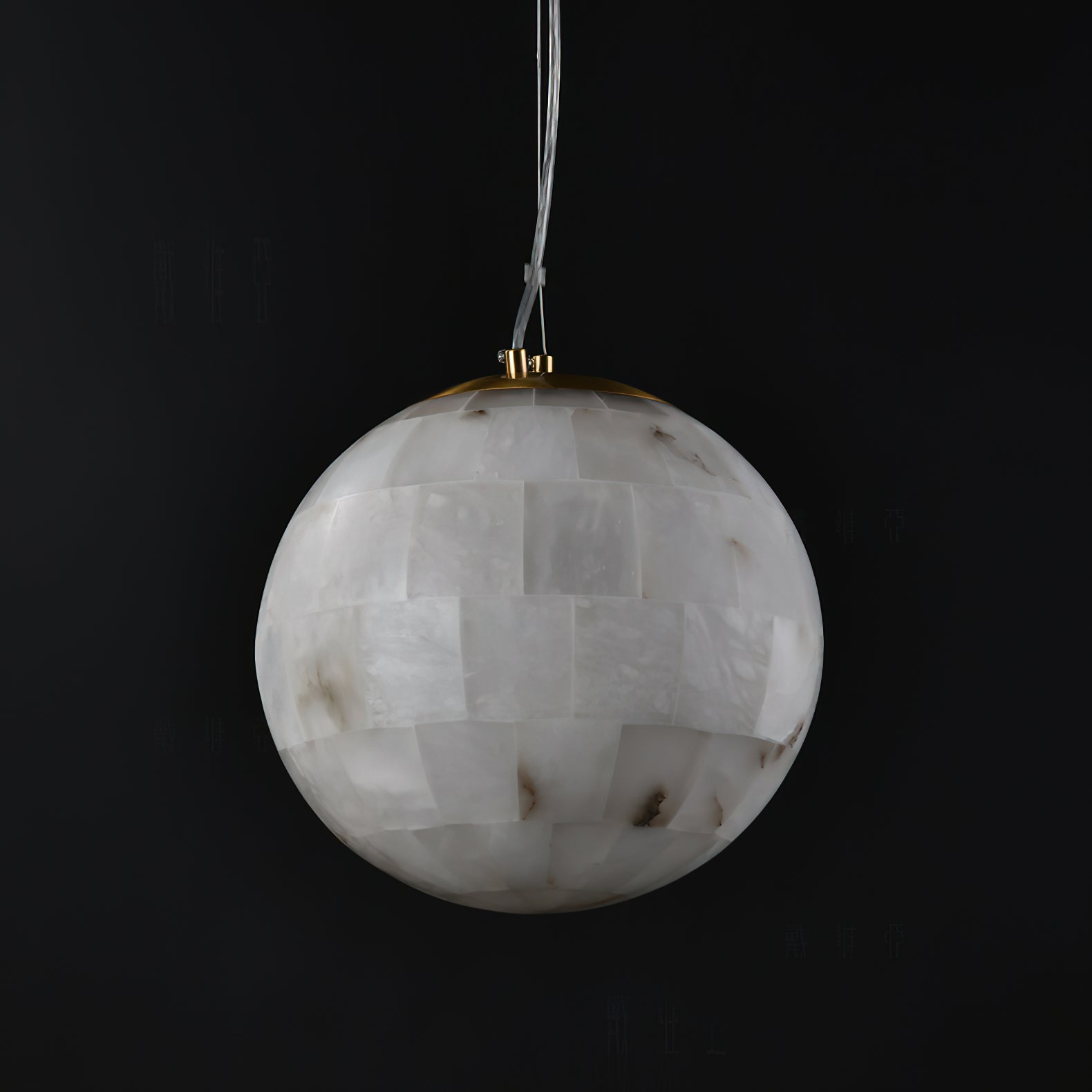Clérachic alabaster globe on black, the hand-tiled stone panels meeting a slim brass collar at the top.