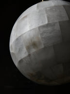 Macro of the Clérachic shade's alabaster tiling, each panel showing its own grey and cream veining.