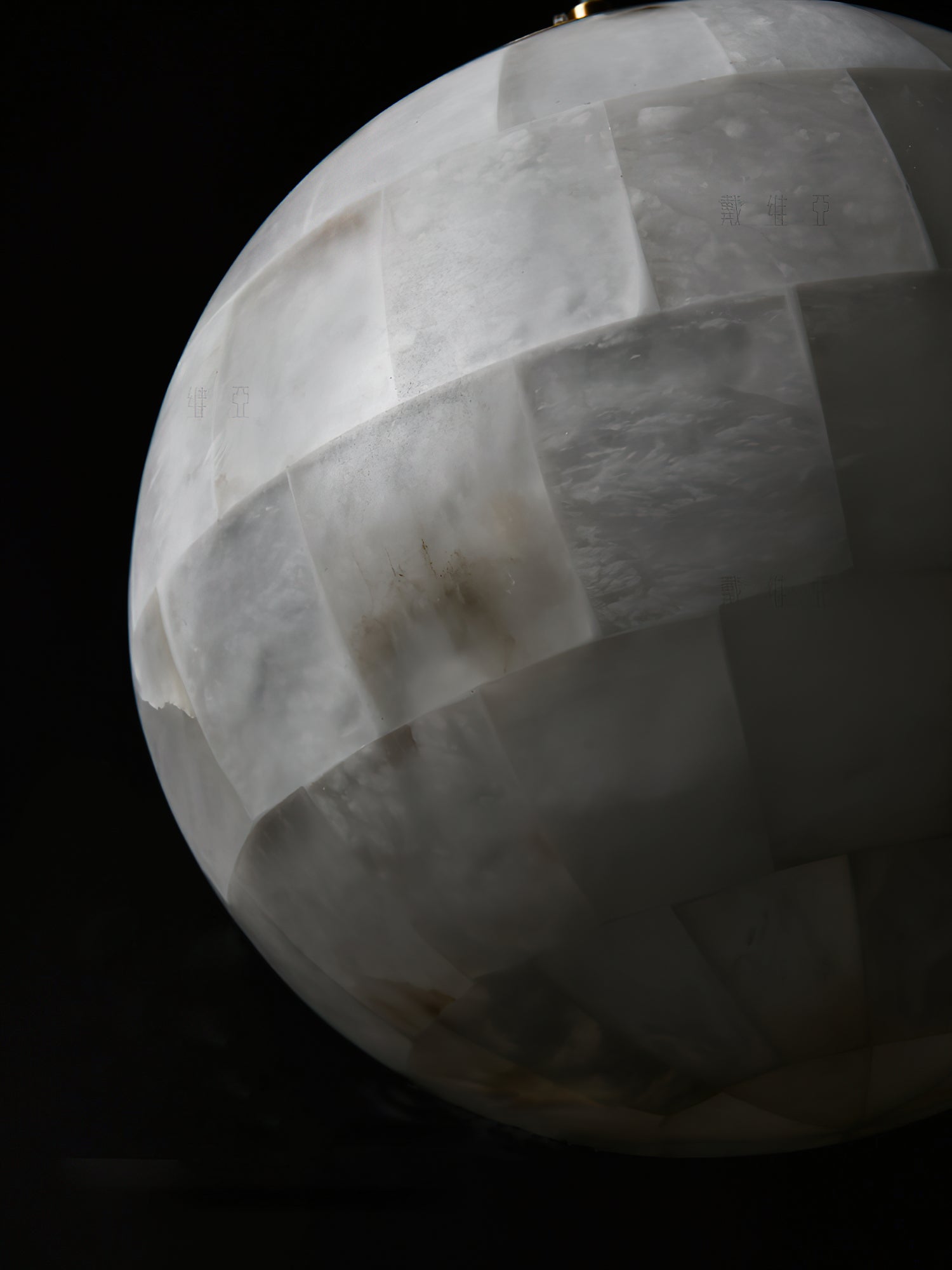 Macro of the Clérachic shade's alabaster tiling, each panel showing its own grey and cream veining.