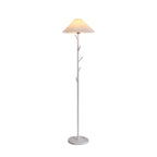 Clérachic floor lamp in white, shown lit against a plain backdrop, with its pleated shade, slim pole and round marble base.