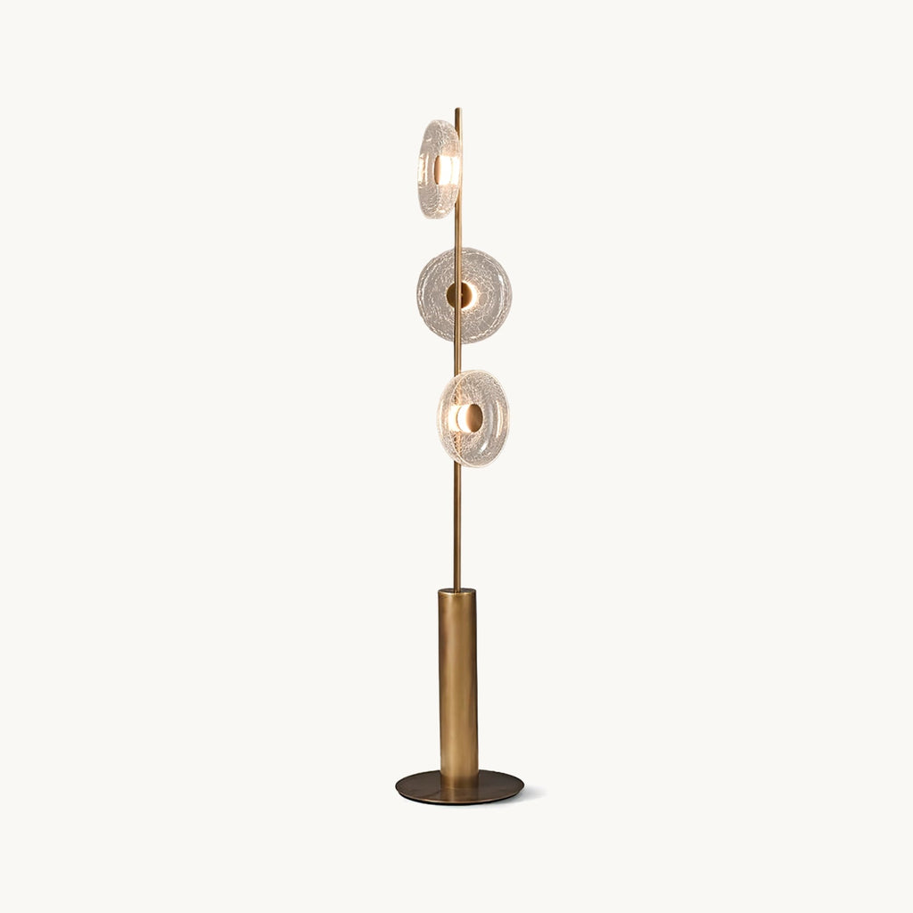 Three cracked glass discs on a slim bronze stem above a cylinder base and round foot, on this Clérachic floor lamp against white.