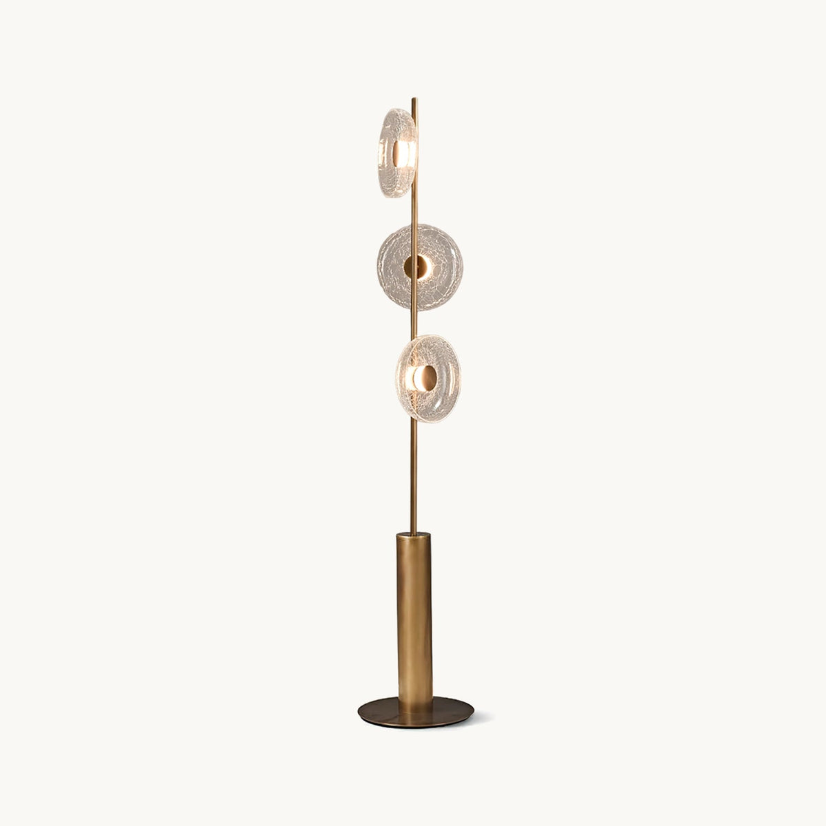 Three cracked glass discs on a slim bronze stem above a cylinder base and round foot, on this Clérachic floor lamp against white.