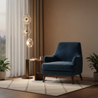 Clérachic floor lamp lit beside a blue armchair and a small round table, with cream curtains and a patterned rug.