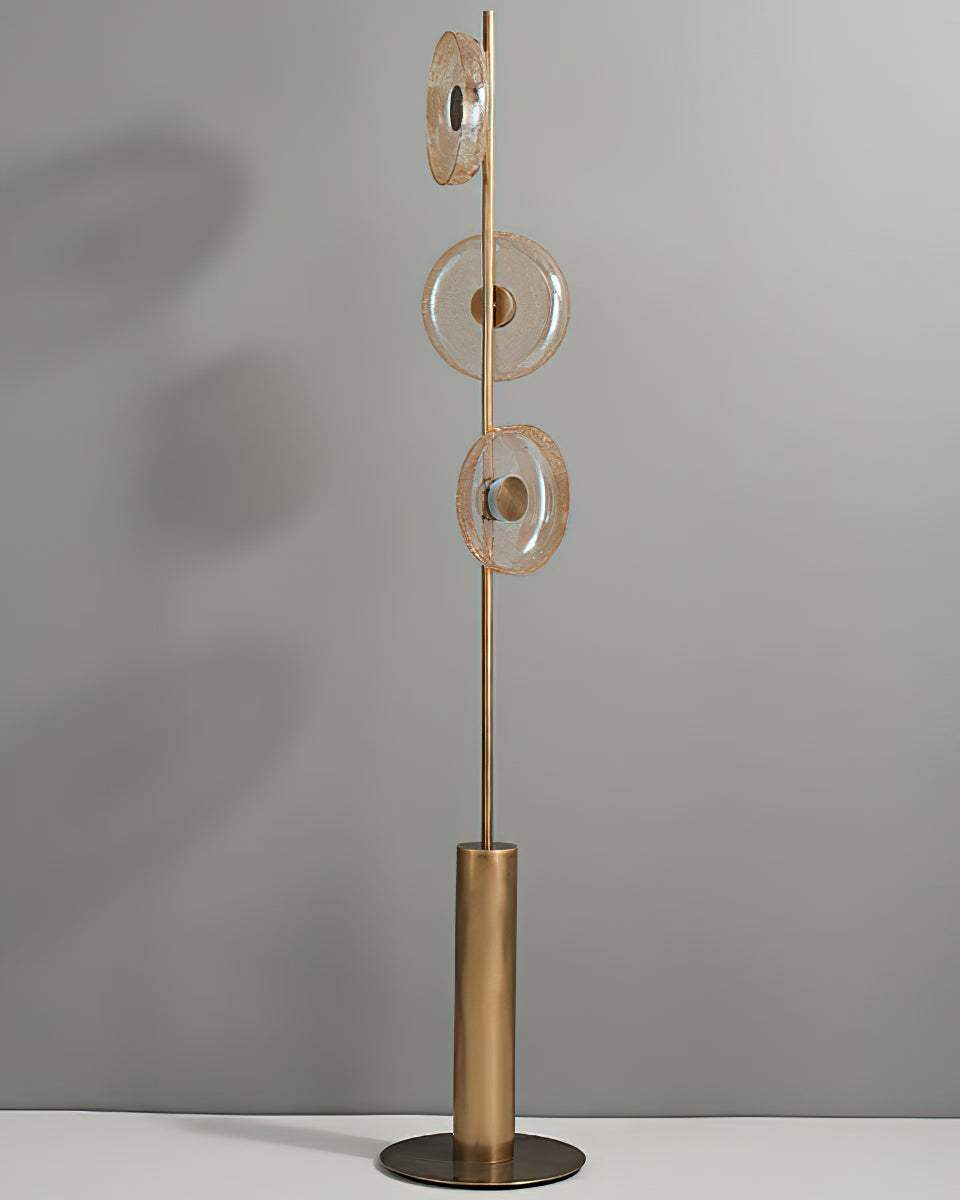 Full view of this Clérachic floor lamp, unlit, with three amber-tinted glass discs on a slim stem above a bronze cylinder base.